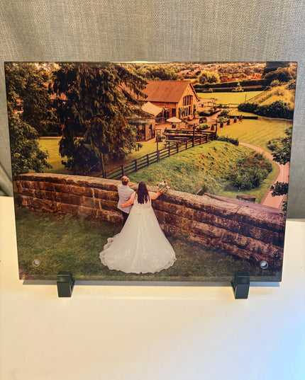 Photo Glass Frame 15x20cm displaying a vibrant wedding photo with a toughened glass and metal frame on a peg stand