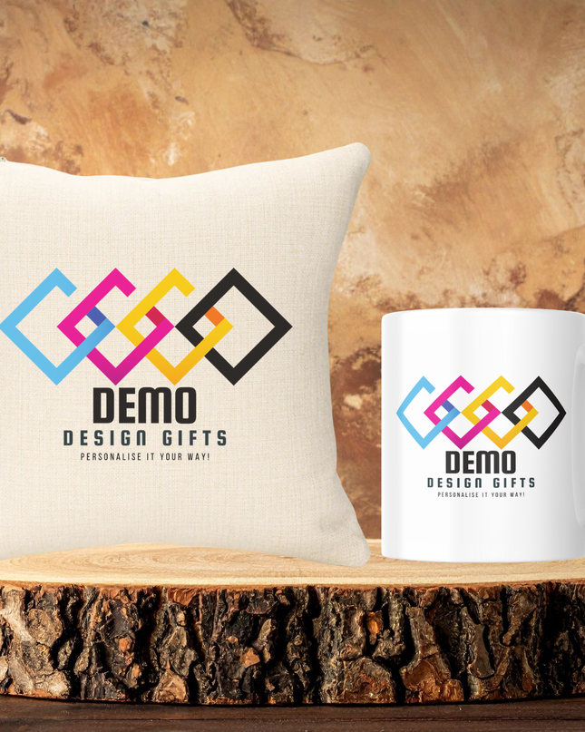 Branded mug with colorful logo and company name on white ceramic beside matching pillow on wooden slab